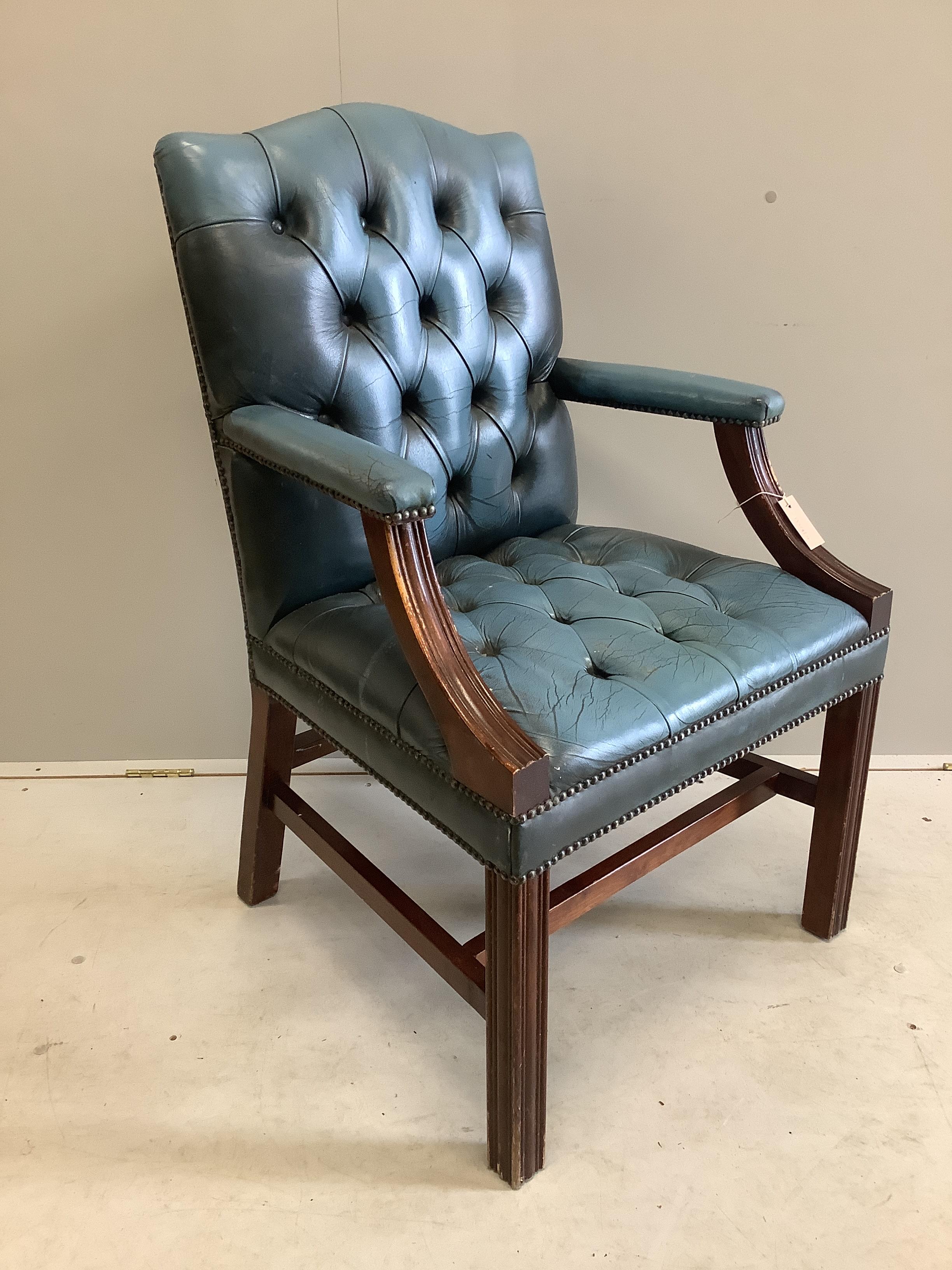 A reproduction Gainsborough style buttoned blue leather library chair, width 60cm, depth 54cm, height 99cm